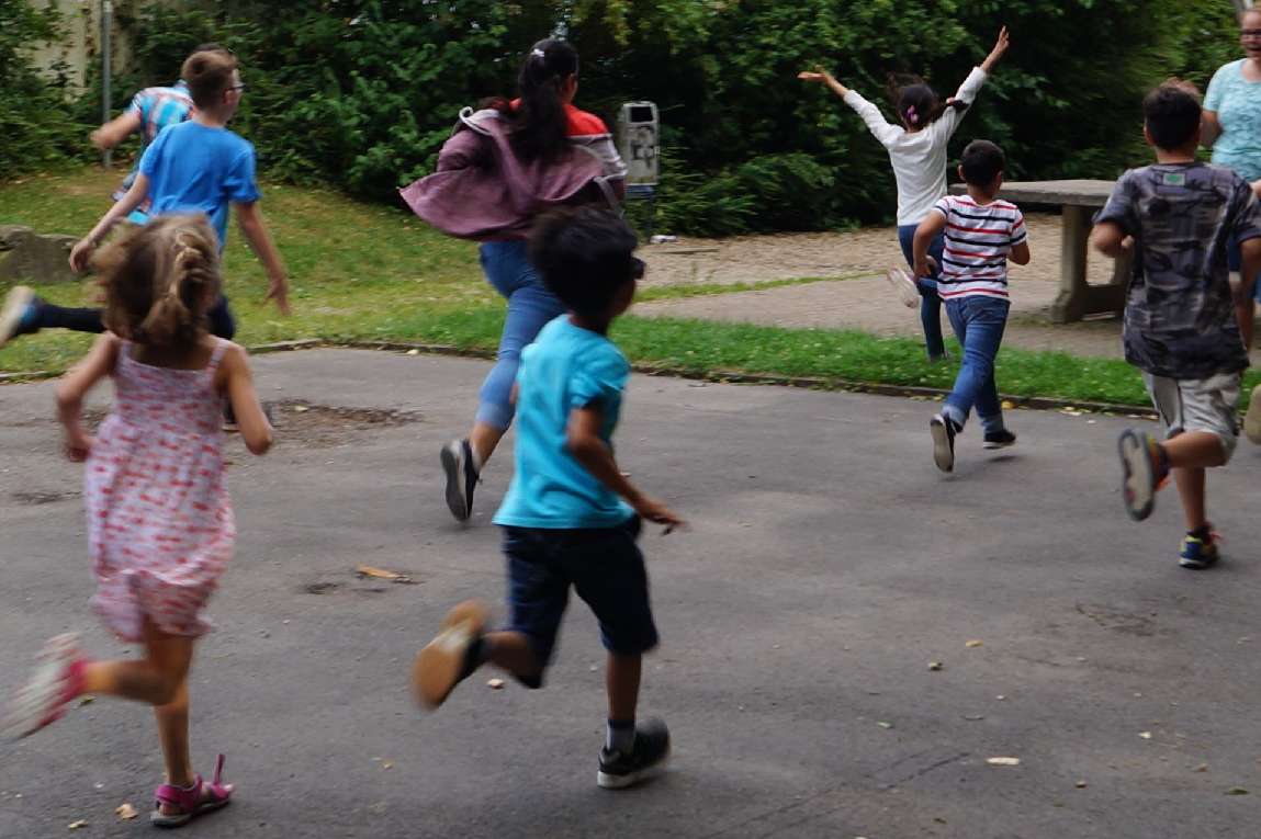 Kinder spielen fangen.